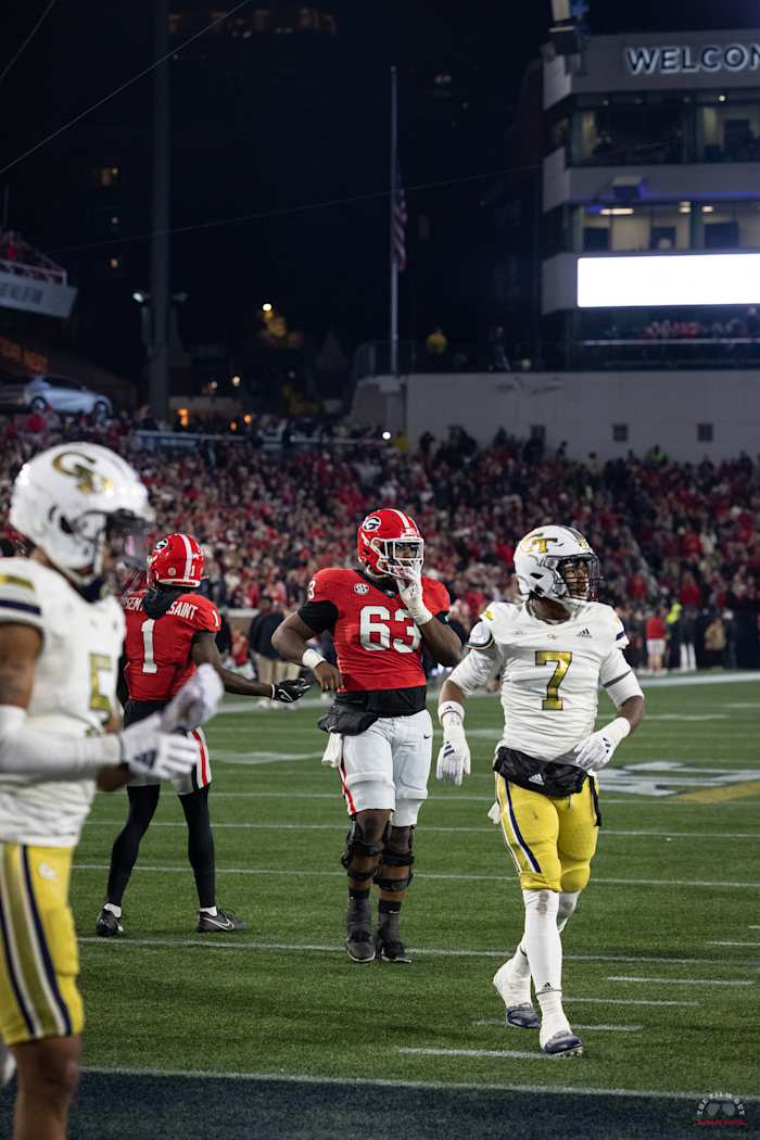 Georgia Bulldogs center (#63) Sedrick Van Pran Granger getting the play call from the sideline during their rivalry game against Georiga Tech on Nov. 25, 2023. (Brooks Austin / Dawgs Daily).